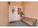 Welcoming front porch with a security screen door, a bench, and decorative plants creating a warm entrance at 5109 Sugarfoot Ave, Las Vegas, NV 89107