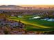 Scenic golf course view with a vibrant green landscape overlooking the Las Vegas skyline at sunset at 5109 Sugarfoot Ave, Las Vegas, NV 89107