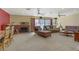 Bright living room featuring a fireplace, multiple sofas, ceiling fans and sliding glass doors to the backyard at 5109 Sugarfoot Ave, Las Vegas, NV 89107