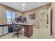 Functional home office equipped with built-in desk space, tile flooring, and natural light from the window at 5109 Sugarfoot Ave, Las Vegas, NV 89107