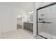Elegant bathroom featuring double vanity, a glass shower, and a walk-in closet for ample storage at 5147 Stonecrop St, North Las Vegas, NV 89031