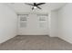 Light and airy bedroom with two windows and neutral carpet at 5147 Stonecrop St, North Las Vegas, NV 89031