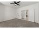 Large bedroom with fan, gray carpet and adjoining room at 5147 Stonecrop St, North Las Vegas, NV 89031