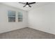 Neutral bedroom featuring two large windows and gray carpet at 5147 Stonecrop St, North Las Vegas, NV 89031