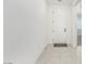 Entryway featuring tile floors and a white front door, creating a clean and welcoming entrance at 5147 Stonecrop St, North Las Vegas, NV 89031