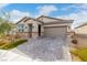 Charming single-story home featuring a paver driveway, neutral stucco, stone accents, and a tile roof at 5147 Stonecrop St, North Las Vegas, NV 89031
