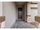 Covered front door and walkway featuring stone accents on the columns, with a view to the garage at 5147 Stonecrop St, North Las Vegas, NV 89031