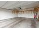 Well-lit two-car garage with painted walls and wood shelving at 5147 Stonecrop St, North Las Vegas, NV 89031