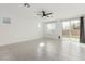 Bright living room featuring tile floors, a ceiling fan, and sliding glass doors to the backyard at 5147 Stonecrop St, North Las Vegas, NV 89031