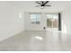 Bright living room featuring tile floors, a ceiling fan, and sliding glass doors to the backyard at 5147 Stonecrop St, North Las Vegas, NV 89031