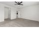 Spacious main bedroom featuring plush gray carpet, a ceiling fan, and neutral walls at 5147 Stonecrop St, North Las Vegas, NV 89031