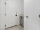 Mud room with a gray vanity and a white door leading outside at 5147 Stonecrop St, North Las Vegas, NV 89031