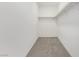 Large walk-in closet with gray carpet and wooden shelves at 5147 Stonecrop St, North Las Vegas, NV 89031