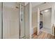 Bright bathroom featuring a glass-enclosed shower and wood-look flooring at 5751 E Hacienda Ave # 172, Las Vegas, NV 89122