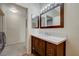 Bathroom with wood vanity and mirrors adjacent to laundry room at 5751 E Hacienda Ave # 172, Las Vegas, NV 89122