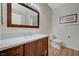 Bathroom with wood-look flooring, dark wood vanity, and bright vanity lighting at 5751 E Hacienda Ave # 172, Las Vegas, NV 89122