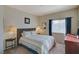 Cozy bedroom with carpet, lamps on side tables, and a window at 5751 E Hacienda Ave # 172, Las Vegas, NV 89122