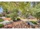 Beautiful courtyard featuring mature trees, lush landscaping, stone benches, and walking paths at 5751 E Hacienda Ave # 172, Las Vegas, NV 89122