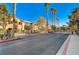 Gated community entrance lined with palm trees and landscaping at 5751 E Hacienda Ave # 172, Las Vegas, NV 89122