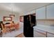 Open floor plan kitchen with modern black refrigerator flowing to dining area at 5751 E Hacienda Ave # 172, Las Vegas, NV 89122