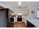 Bright kitchen featuring white cabinets, modern appliances, and wood flooring at 5751 E Hacienda Ave # 172, Las Vegas, NV 89122