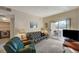 Living room featuring sliding glass doors, a television, sofa and cozy chair at 5751 E Hacienda Ave # 172, Las Vegas, NV 89122