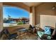 Cozy patio area with seating offering views of the parking area and landscaping at 5751 E Hacienda Ave # 172, Las Vegas, NV 89122