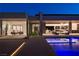 A modern home glows at twilight, showcasing seamless indoor-outdoor living and a stunning pool at 6 Rockmount Ct, Henderson, NV 89012