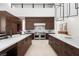 Spacious kitchen with custom cabinets, stainless steel appliances, and large center island with marble countertops at 6 Rockmount Ct, Henderson, NV 89012