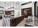 Gourmet kitchen with dual islands, marble counters, pendant lighting, and high-end appliances with mountain views at 6 Rockmount Ct, Henderson, NV 89012