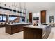 Modern kitchen featuring two large islands with marble countertops, dark wood cabinets, and a breakfast bar at 6 Rockmount Ct, Henderson, NV 89012