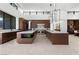 Modern kitchen with brown cabinets, white marble countertops, double islands, and stainless steel appliances at 6 Rockmount Ct, Henderson, NV 89012