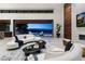 Living room featuring two white sofas, a modern fireplace, and a view of the pool at 6 Rockmount Ct, Henderson, NV 89012