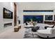 Bright, open living space with modern fireplace and white sofas near a dining area and outdoor patio at 6 Rockmount Ct, Henderson, NV 89012