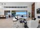 Bright living room with modern white sofas, statement lighting, and an amazing view of the pool and landscape at 6 Rockmount Ct, Henderson, NV 89012