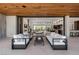 Open indoor/outdoor living space with modern furniture and wood ceiling at 6 Rockmount Ct, Henderson, NV 89012