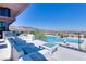 Beautiful pool area with ample lounge seating, cabanas and mountain views in the background at 6 Rockmount Ct, Henderson, NV 89012