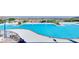 Community pool with lounge chairs, green desert landscaping, mountain views, and cabanas at 6 Rockmount Ct, Henderson, NV 89012