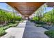 Covered walkway featuring desert landscaping with trees and decorative stone with geometric paving at 6 Rockmount Ct, Henderson, NV 89012