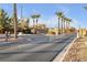 Gated entrance to a community with lush landscaping and well-maintained streets at 6112 Wheat Penny Ave, Las Vegas, NV 89122