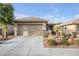 Inviting single-story home showcasing a well-maintained front yard and a convenient two-car garage at 6112 Wheat Penny Ave, Las Vegas, NV 89122