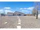 Expansive backyard with stepping stones leading up to the residence at 6120 Farm Rd, Las Vegas, NV 89131