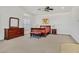 Bedroom with a wood dresser and a sleigh bed featuring a padded bench at 6120 Farm Rd, Las Vegas, NV 89131