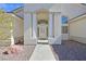 Inviting home entrance with grand columns, desert landscaping and elegant details at 6120 Farm Rd, Las Vegas, NV 89131