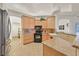 Well-equipped kitchen featuring granite countertops and bright wood cabinets at 6120 Farm Rd, Las Vegas, NV 89131