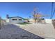 Spacious backyard with desert landscaping has a patch of green grass and a detached garage at 617 Carpenter Dr, Las Vegas, NV 89107