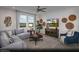 A living room area features neutral tones, a ceiling fan, and a large window with scenic views at 6668 Nimbus Ave # Lot 22, Las Vegas, NV 89130