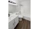 Bright bathroom features a modern vanity, toilet, tub, and shower combo with wood look flooring at 6701 Squaw Mountain Dr # 201, Las Vegas, NV 89130
