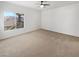 Spacious bedroom with a ceiling fan and natural light from a large window at 6701 Squaw Mountain Dr # 201, Las Vegas, NV 89130