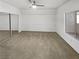 Empty carpeted bedroom with sliding closet doors and a window at 6701 Squaw Mountain Dr # 201, Las Vegas, NV 89130